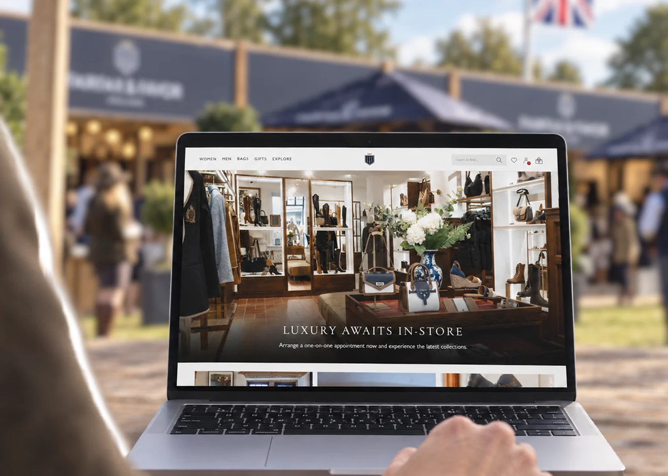 Fairfax & Favor Shopify website on a laptop at an outdoor brand event