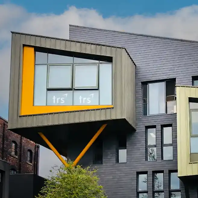 The TRS studio building in Lincoln, with a cantilevered window carrying the TRS mark