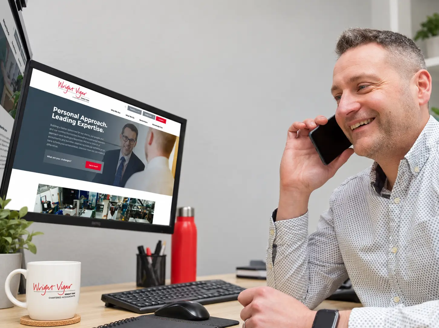Wright Vigar website on a desktop in their office, with a member of the team on a call